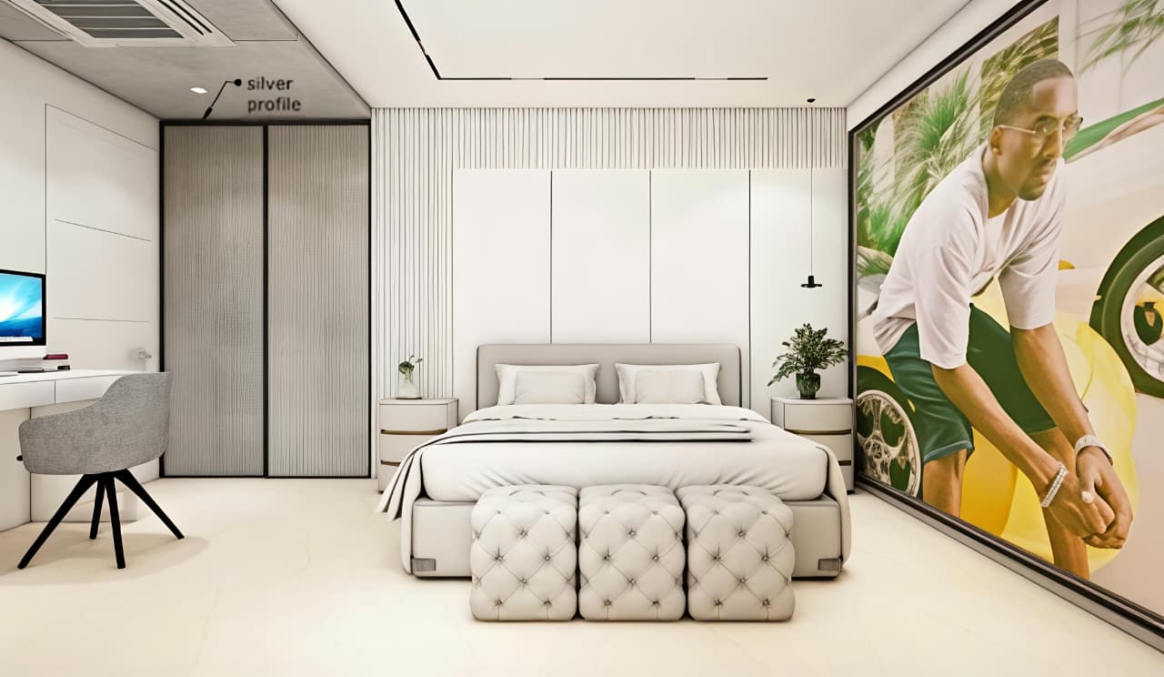 Primary bedroom — upholstered headboard wall with bespoke wardrobes and feature art.
