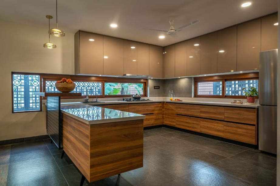 Modular kitchen — warm wood cabinetry with a glass-topped island.