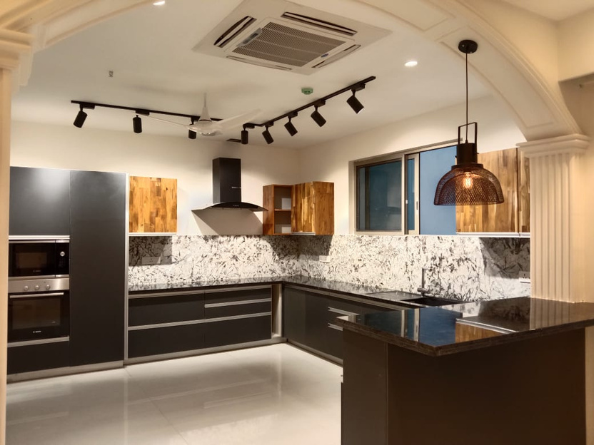 Kitchen — dark cabinetry against a hand-veined marble backsplash.