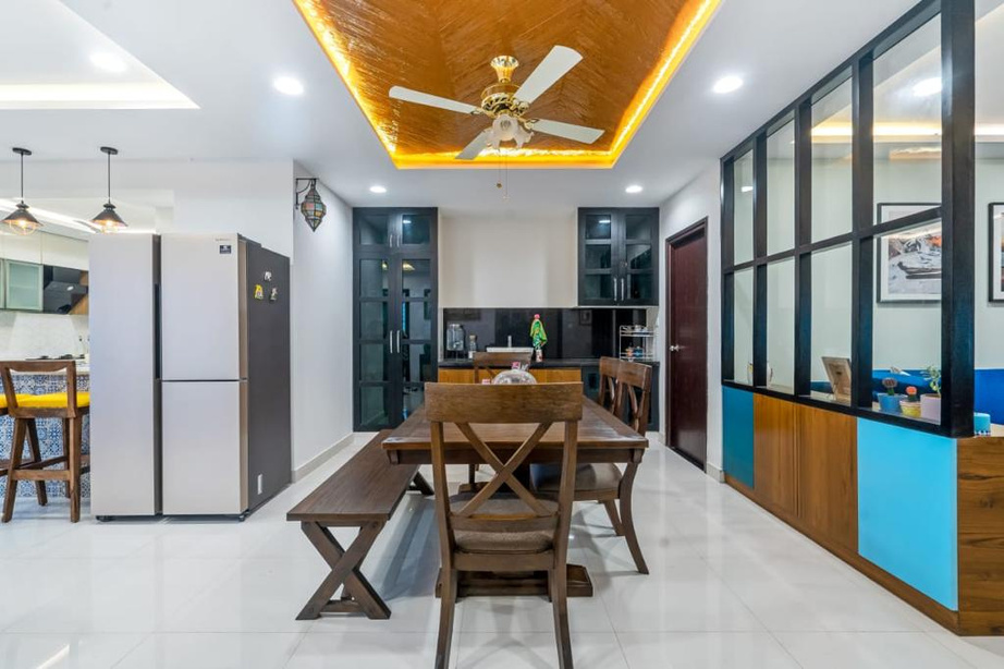 Dining — a quiet, tonal moment under a sculptural fan.