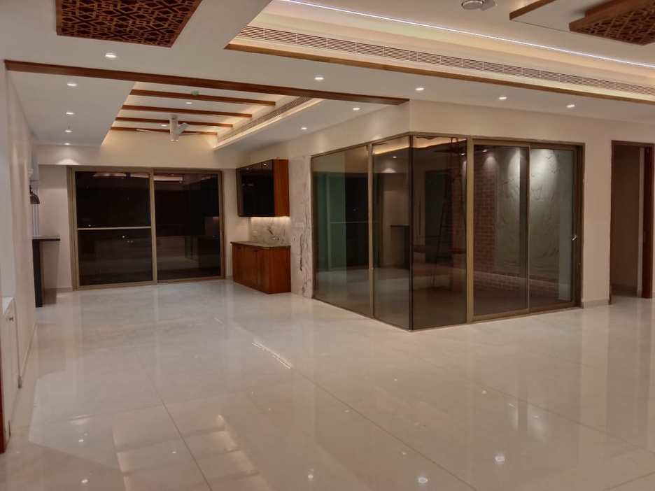 Open volume — wooden ceiling accents and sliding glass to the balcony.